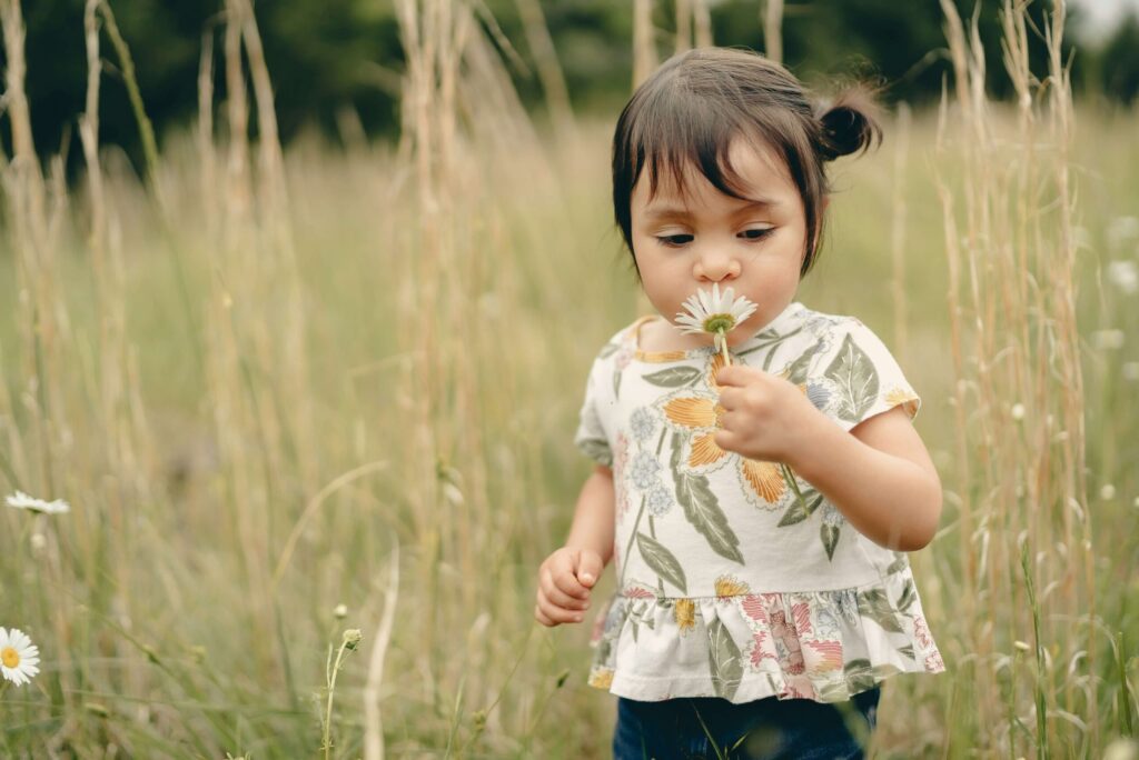 Child marveling at nature — inspired by childhood spiritual wisdom and the message of Little Guru & Co.